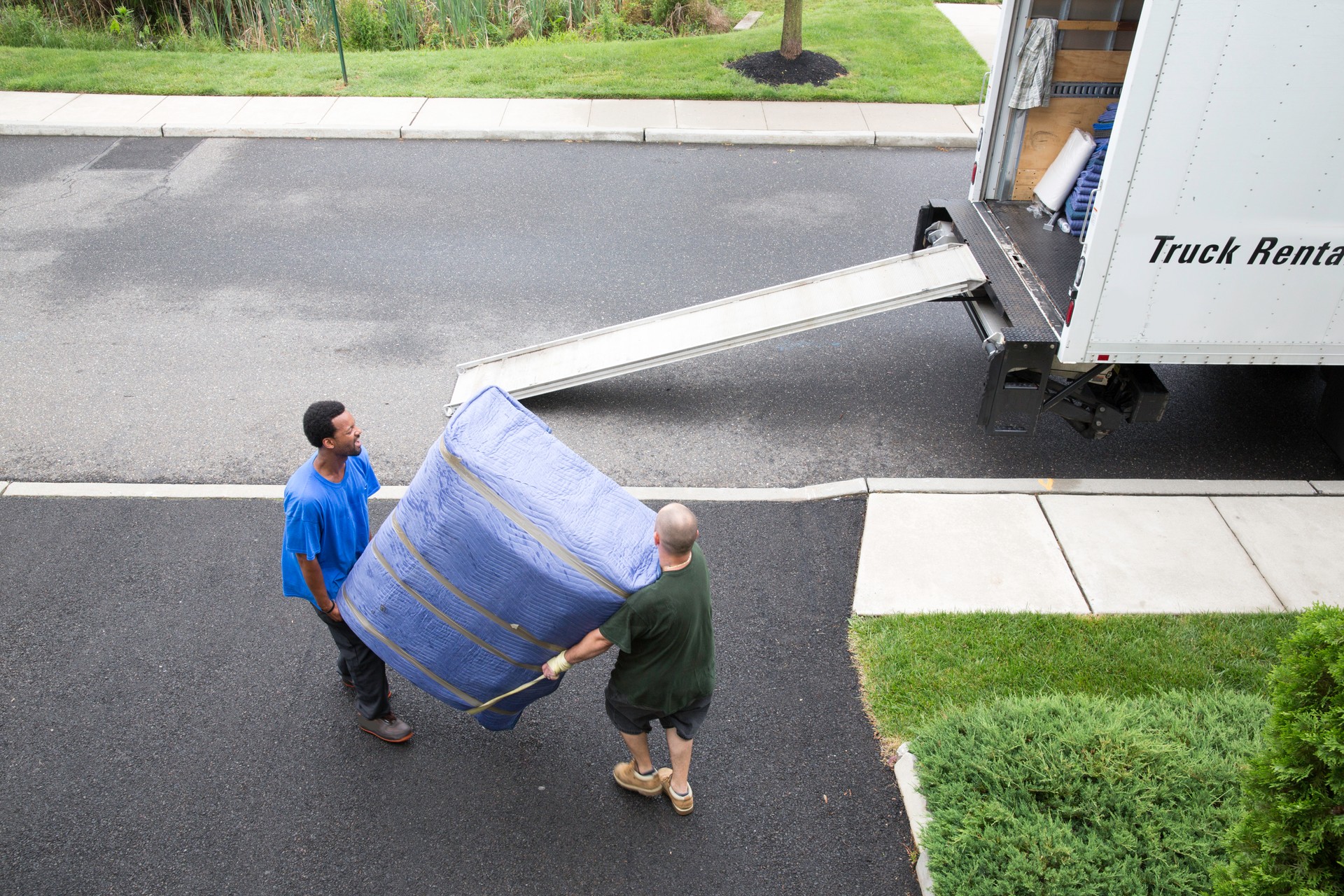 Movers get ready to load furniture onto moving van